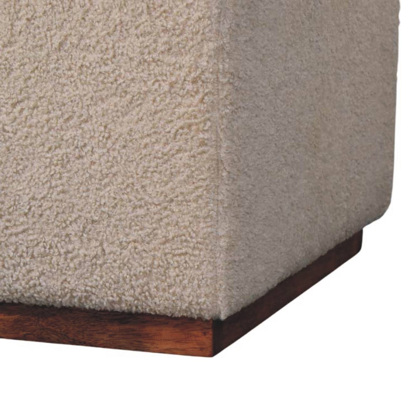 Close-up of a textured beige surface with a wooden base