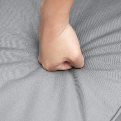 Close-up of a foot on a gray fabric surface