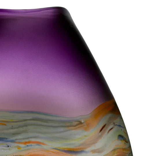 Close-up of a purple glass vase with multicolored marbled design on a white background