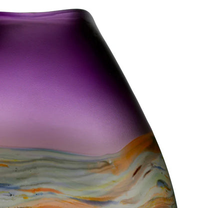 Close-up of a purple glass vase with multicolored marbled design on a white background