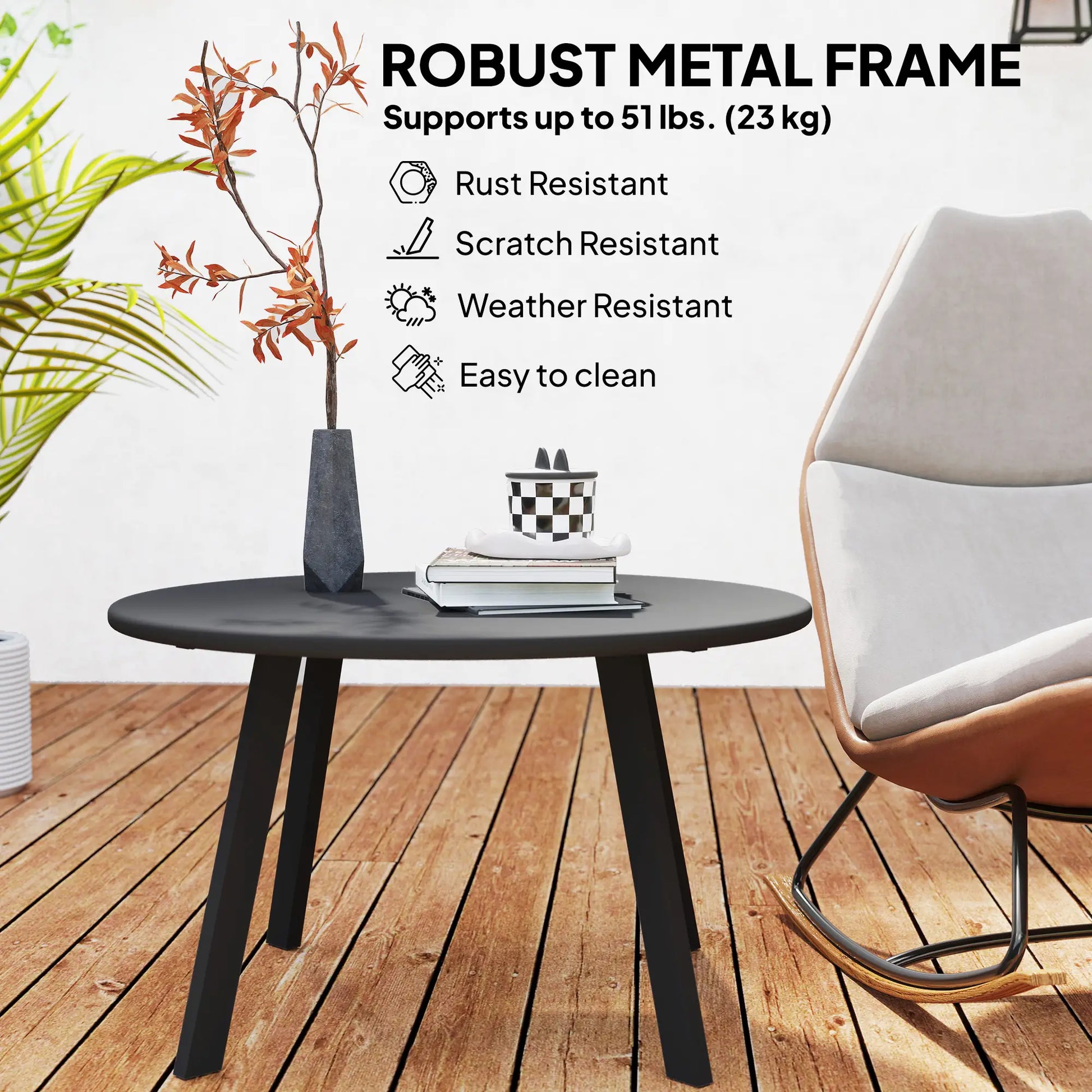 Black metal table with chair on a wooden deck, featuring robust metal frame details.