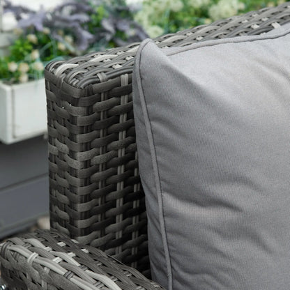 Gray wicker chair with a cushion in an outdoor setting
