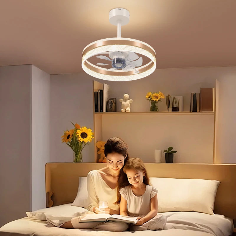 Woman and child reading a book on a bed with a modern ceiling fan above.