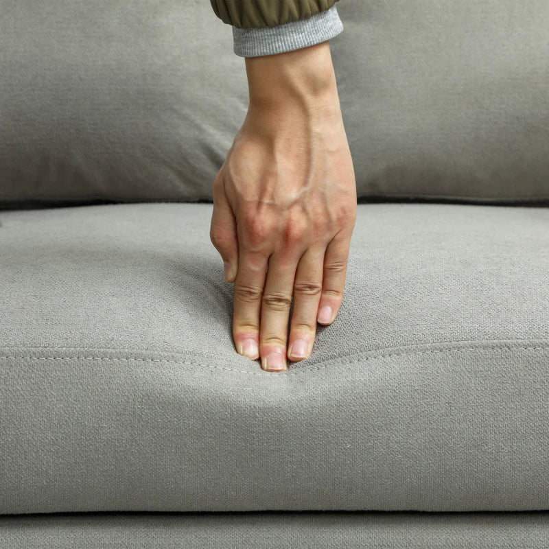 Hand resting on a gray sofa