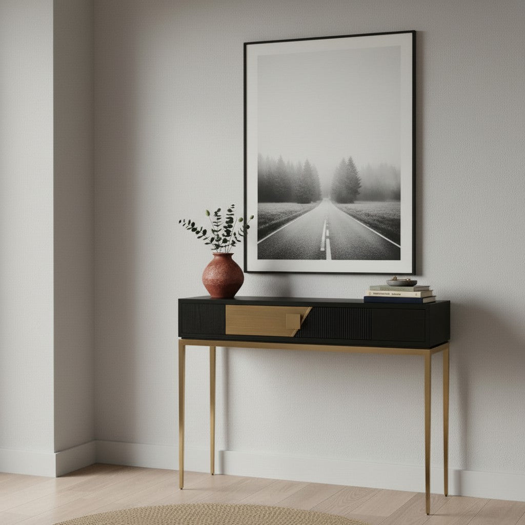 Console table with decorative items and a framed photograph on a wall.