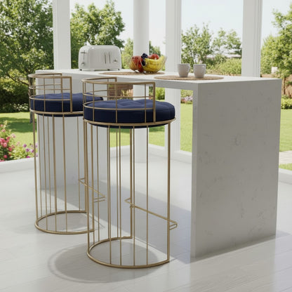 Two gold stools with navy cushions in front of a white outdoor bar.