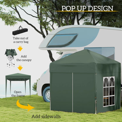 Green pop-up canopy tent being set up with instructions on a grassy area with trees and a caravan in the background.