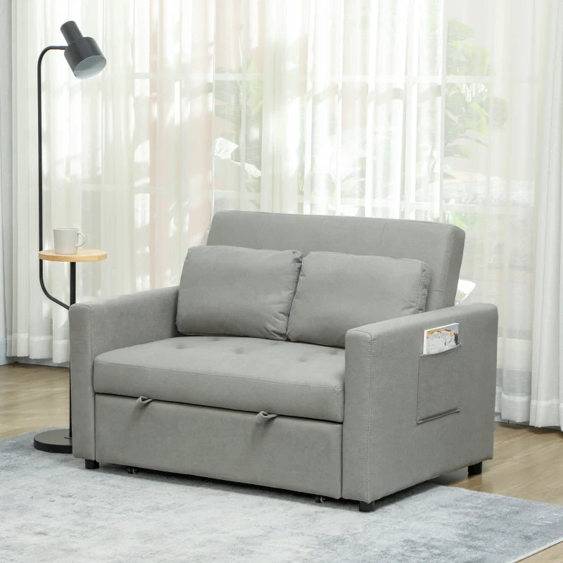 Gray sofa bed in a room with light curtains and a lamp.