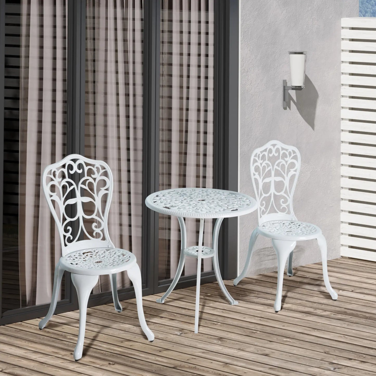 White metal outdoor table and chairs on a wooden deck