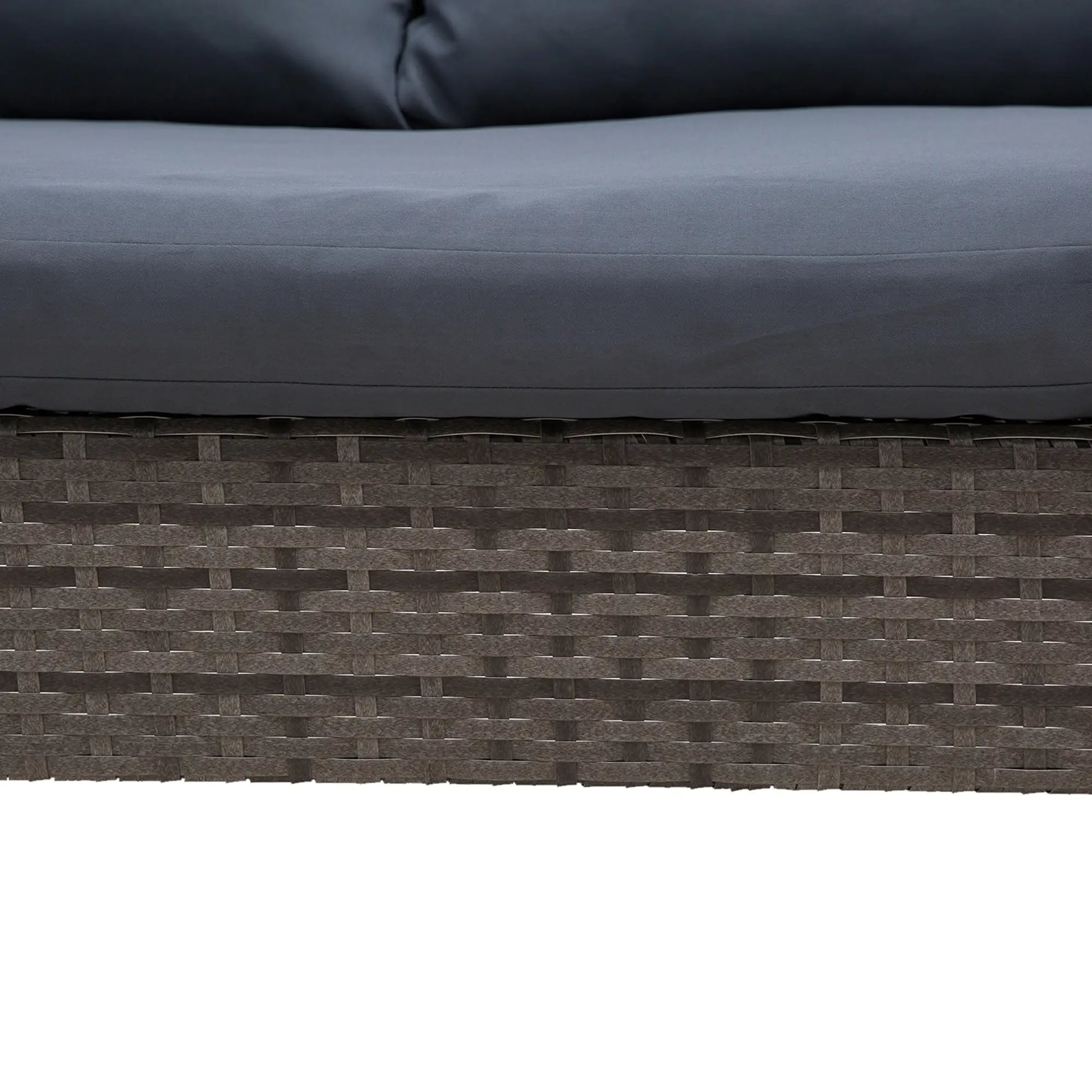 Close-up of a textured surface with a woven pattern and dark cushions.