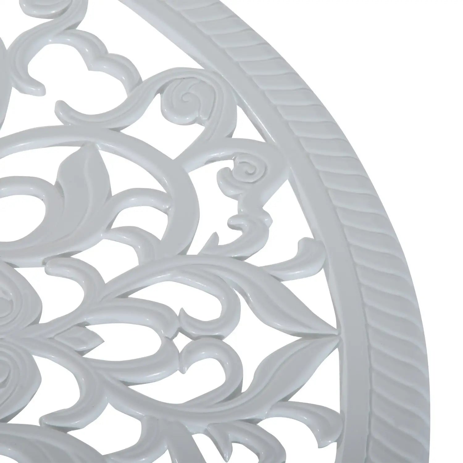 Close-up of a decorative white metal grill with intricate patterns on a white background