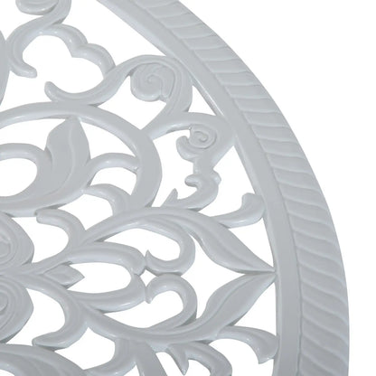 Close-up of a decorative white metal grill with intricate patterns on a white background