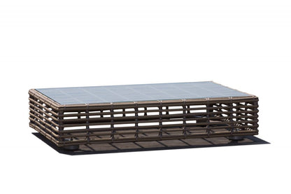 Rattan coffee table with glass top on a white background