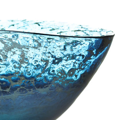 Close-up of a blue glass bowl with textured surface on a white background