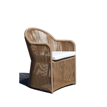 Wicker chair with a white cushion on a white background