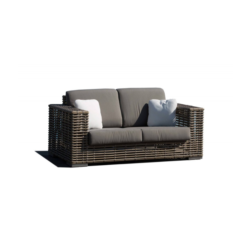 Wicker outdoor sofa with cushions on a white background