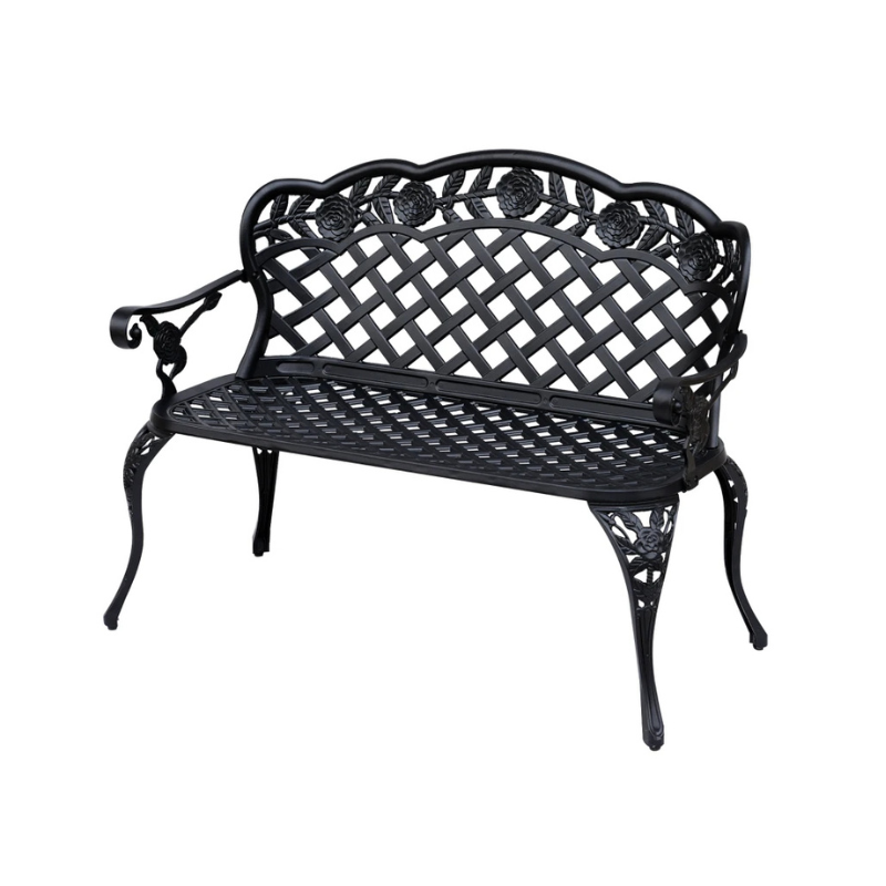Black metal garden bench with intricate design on a white background