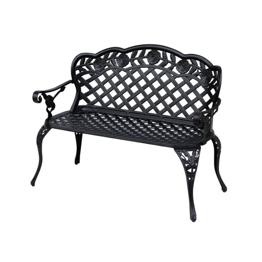 Black metal garden bench with intricate design on a white background