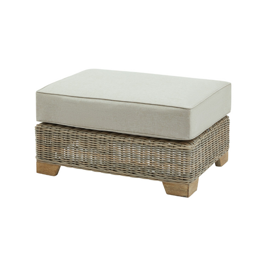 Wicker ottoman with a cushion on a white background