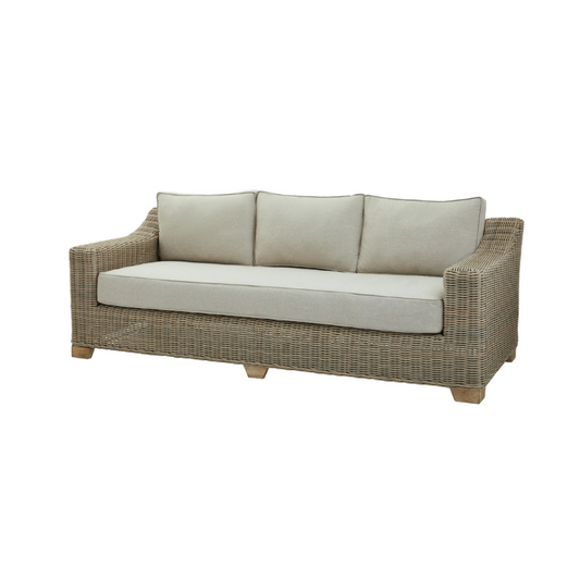 Wicker outdoor sofa with beige cushions on a white background