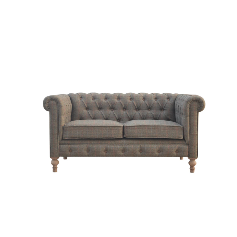 Gray tufted sofa on a white background