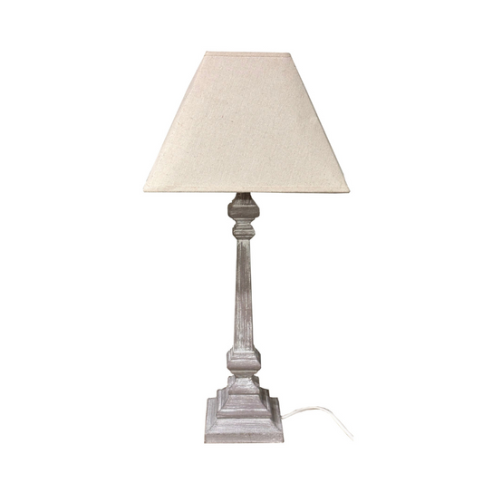 Table lamp with beige shade and wooden base on a white background