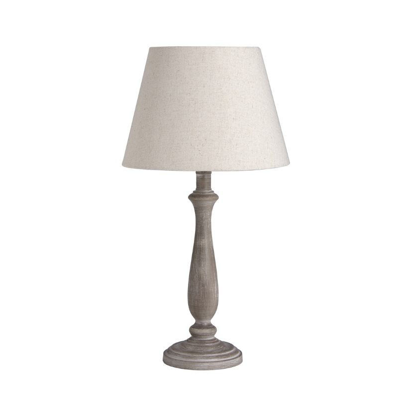 Table lamp with a beige shade and wooden base on a white background