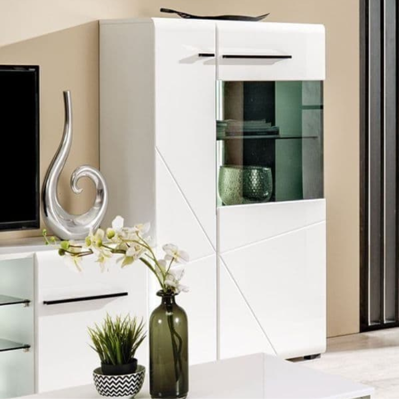 Modern living room with white cabinet, decorative vase, and plants.