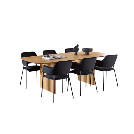 Wooden dining table with black chairs on a white background