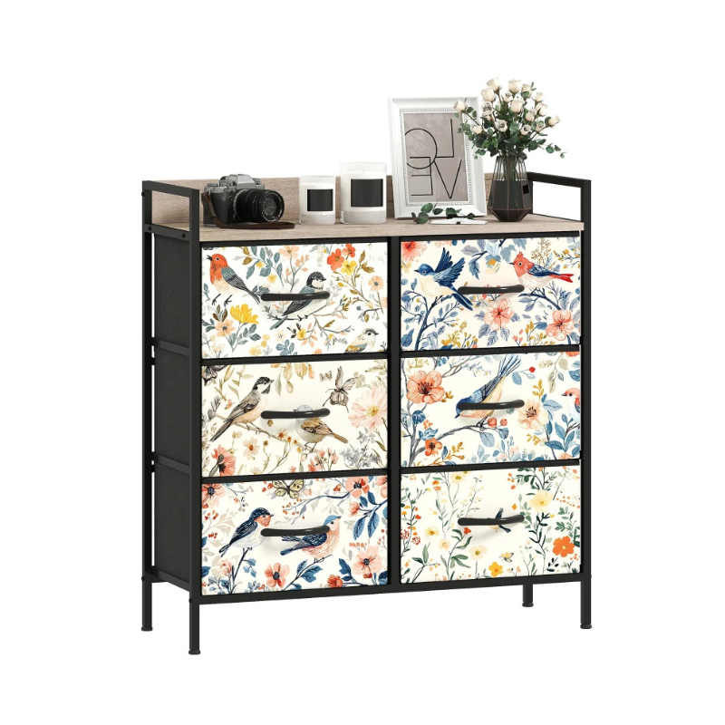 Decorative dresser with floral and bird patterned drawers on a white background