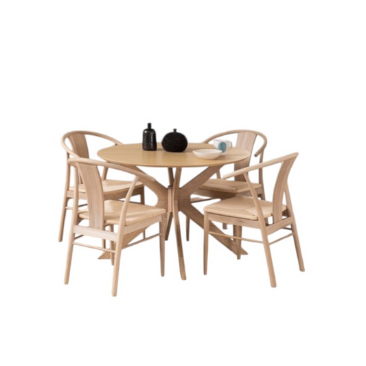 Round wooden table with four matching chairs on a white background