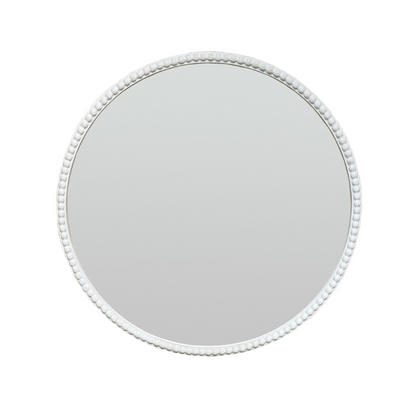 Round mirror with a decorative white frame on a white background