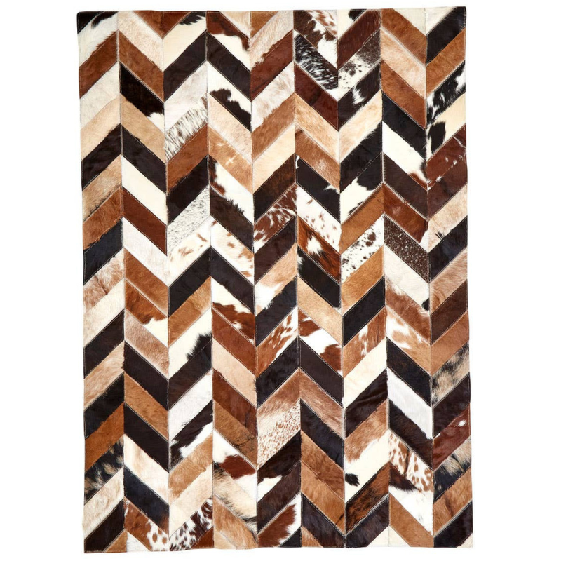 Rug with a chevron pattern featuring brown, black, and white colors on a white background