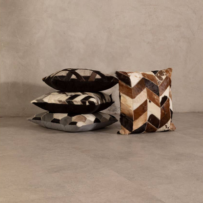 Three patterned pillows on a neutral background