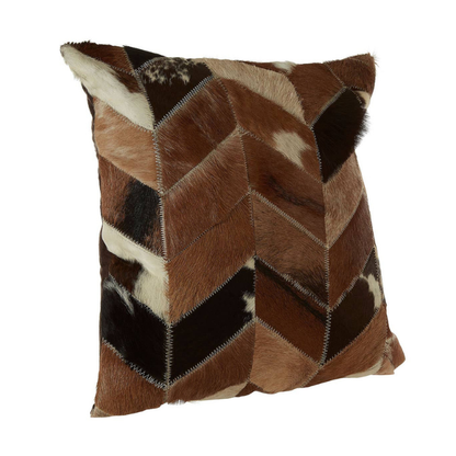 Patchwork pillow with brown, black, and white pattern on a white background