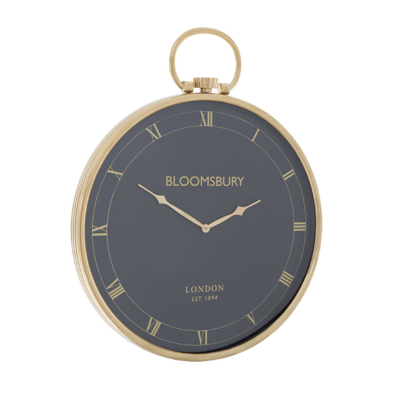 Pocket watch with gold frame and dark face displaying 'Bloomsbury London'.