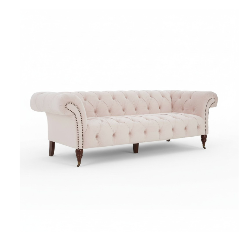 Pink tufted sofa with wooden legs on a white background