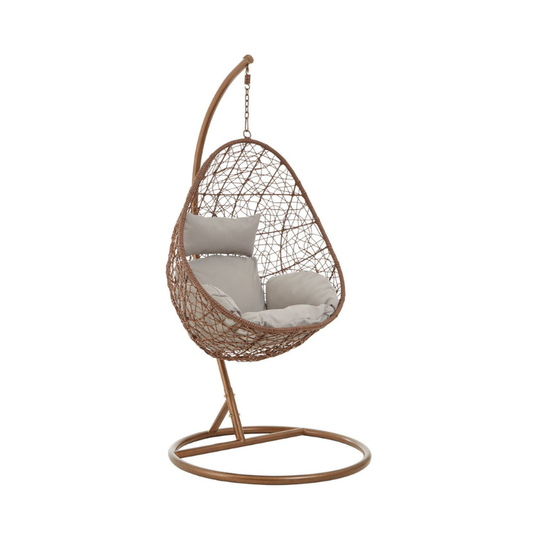 Interior by Premier Solana hanging chair with woven rattan design and plush cushion for comfortable indoor or outdoor relaxation.
