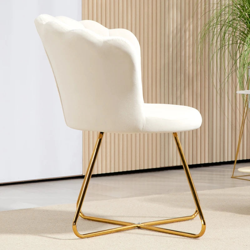 White chair with gold legs in a minimalistic room with a plant.