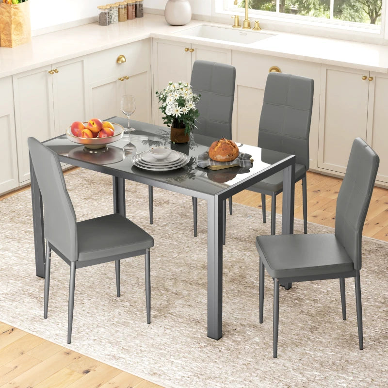 Dining table set with four gray chairs in a kitchen.