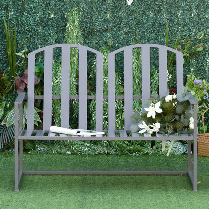 Gray metal bench with a tennis racket and flowers on a green grass background