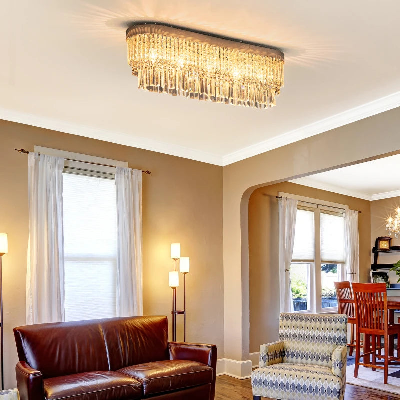 Living room with a chandelier, brown leather sofa, and patterned armchair.