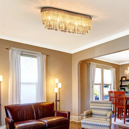 Living room with a chandelier, brown leather sofa, and patterned armchair.