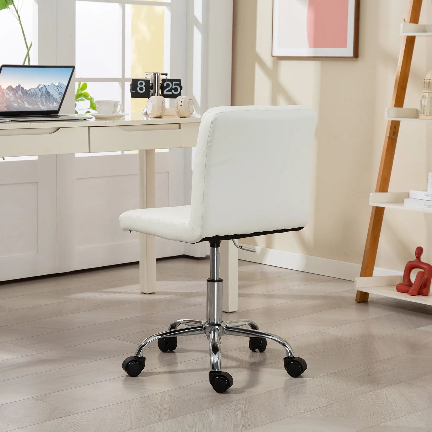 White office chair in a home office setting with a desk and decor.