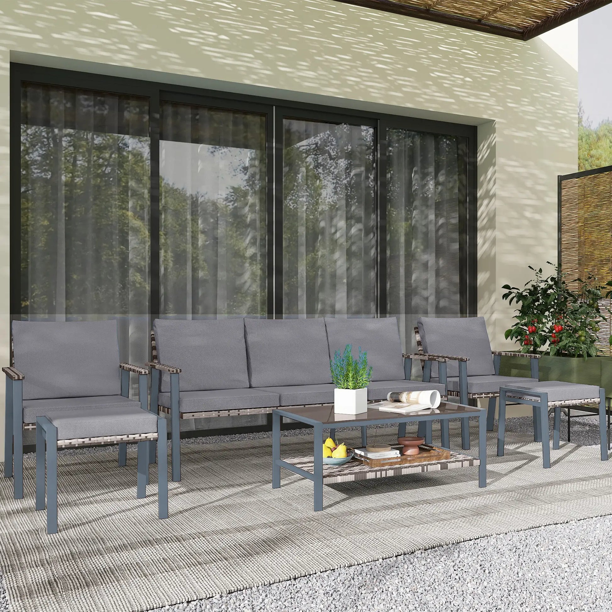 Outdoor patio set with gray cushions on a patio area.