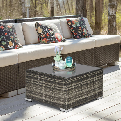 Outdoor patio set with wicker furniture and decorative cushions on a wooden deck.