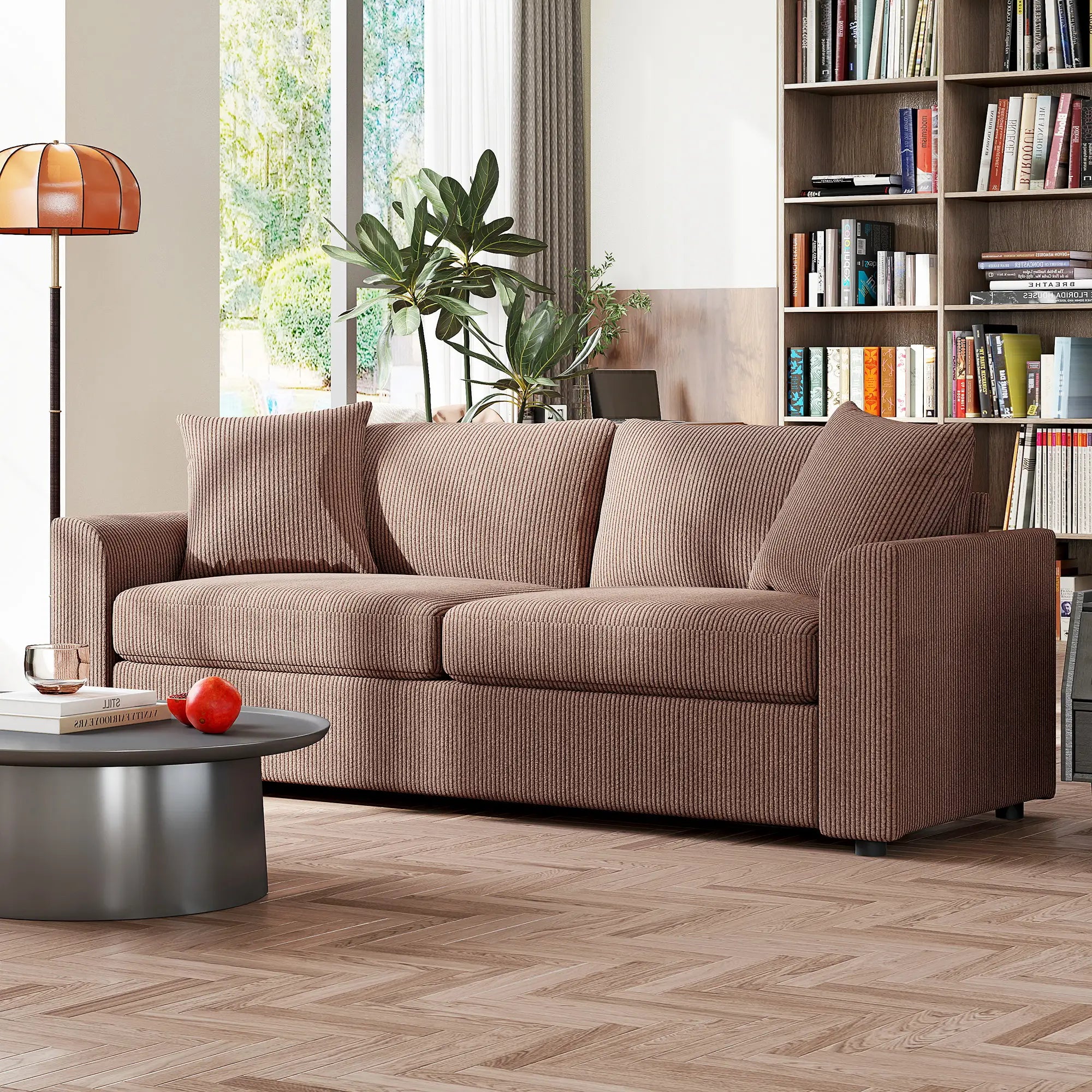 Brown sofa in a living room with a bookshelf and lamp in the background