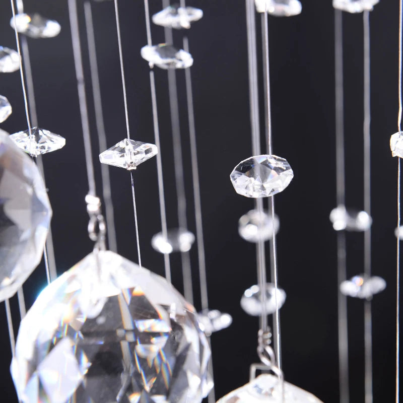 Close-up of hanging crystal prisms against a black background