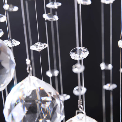 Close-up of hanging crystal prisms against a black background