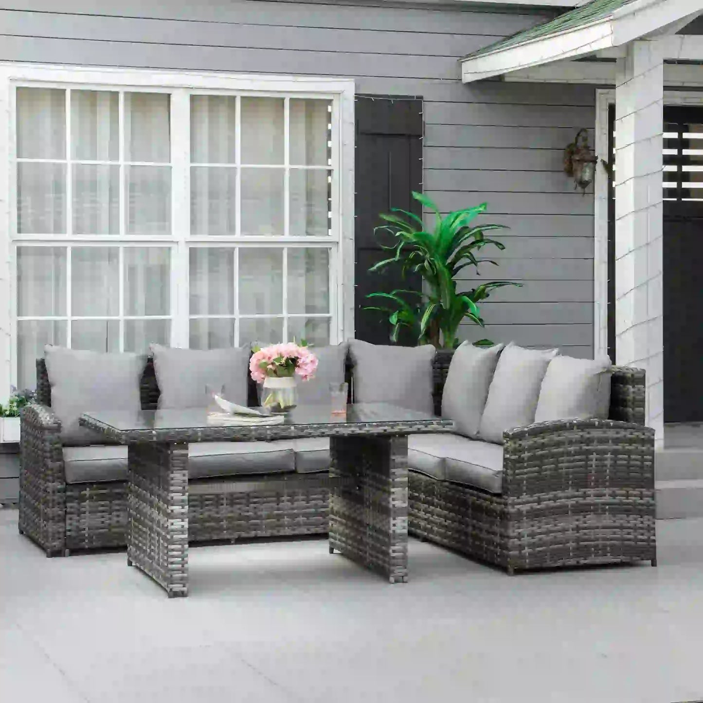 Outdoor patio furniture set with a table and chairs on a patio.